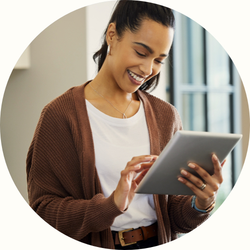 female smiling at tablet in hand